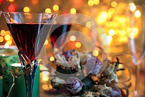 Close-up of red wine in glasses,candle and flowers