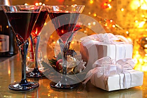 Close-up of red wine in glasses,candle and gifts