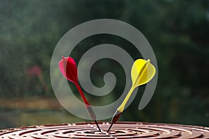 Close-up of red and yellow darts in the center of the target. Success and goal achievement concept. Selective focus