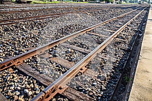 Close up of redirection old train or railroad tracks with wooden backing In the countryside