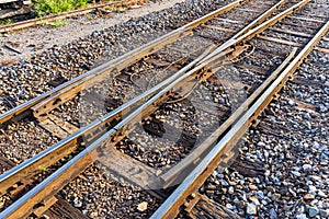Close up of redirection old train or railroad tracks with wooden backing In the countryside