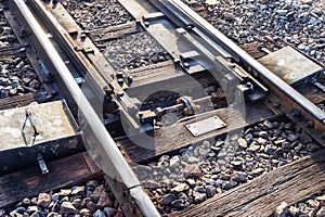 Close up of redirection old train or railroad tracks with wooden backing In the countryside photo