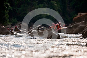 Close-up of reef while young person rafting on the river in blurred background