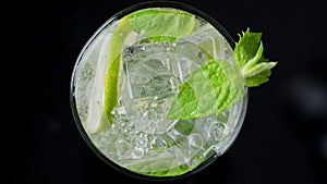 Close-up refreshing soda tonic. Pour carbonated water into a glass of lime and ice. Cold Mojito lemonade