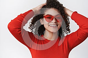 Close-up relaxed joyful good-looking woman curly-haired enjoy weekend vacation look happily smilling toorhy hold hands