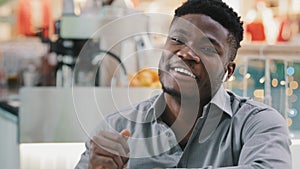 Close-up relaxed satisfied happy young african american man sitting listening to modern dynamic music in wireless