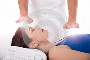 Woman Having Reiki Healing Treatment photo