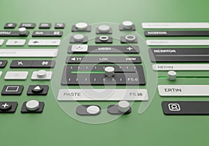Close-up of Remote Control with Black White and Gray Buttons on Green Background