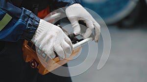 Close-up. Remote control crane beam in an industrial warehouse. The worker is loading and unloading.