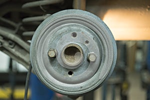 Close-up repair drum brake of car wheel in garage.