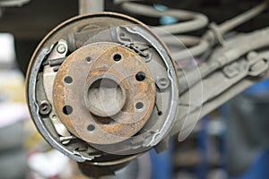 Close-up repair drum brake of car wheel in garage.