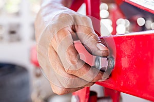 Close up of repair mechanic hands install bolts & nuts of piping, Worker`s hand tightens the nut on the bolt