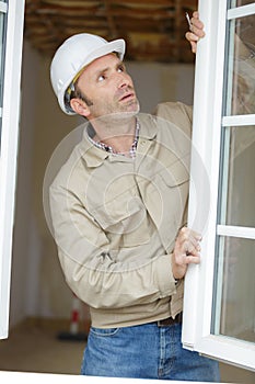 close up repairman fixing window