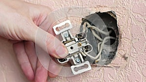 Close-up of replacing an old burnt out electrical outlet. Repair of electrical wiring in the apartment. A specialist installs an e