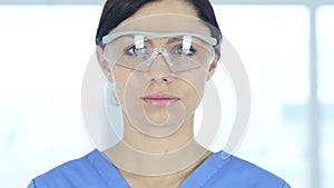 Close up of reseach scientist, doctor in protective glasses