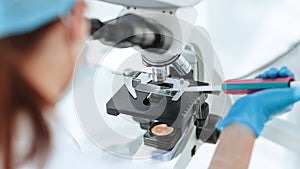 Close up. researcher testing the blood under a microscope.