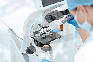 close up. researcher testing the blood under a microscope.