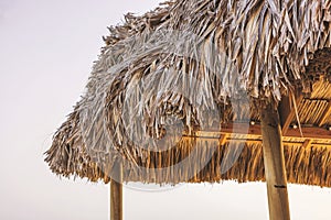 Close-up of the restaurant roof made of palm leaves on the shores of the Caribbean Sea.
