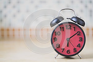 Close up of retro alarm clock on table in the morning