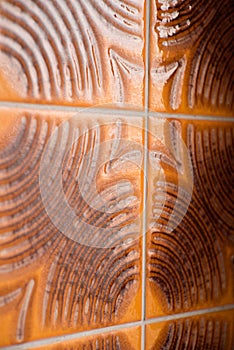 Close-up of retro style brown and orange bathroom tiles