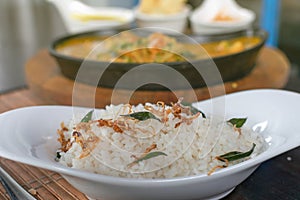 Close up of rice with shrimps curry in a pan on the background