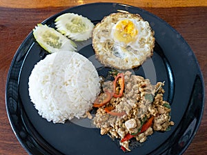 Close up Rice with stir fried minced pork, fried egg and basil.