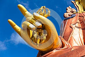 Close up at the right golden hand with mace of Guru Rinpoche statue, the patron saint of Sikkim in Guru Rinpoche Temple at Namchi.