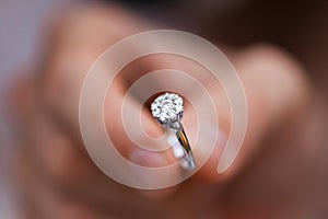 Close-up of a ring in a mans hand. young man giving engagement ring to his girlfriend. Man making marriage proposal to