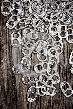Close up rings pull aluminum of soda or beer can isolate on wood background.