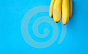Close up of ripe banana bunch on blue background