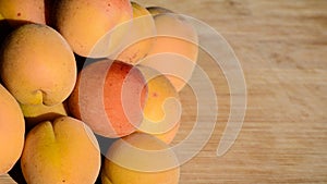 Close up of ripe Blenheim apricots freshly picked, on a wooden table; Blenheim apricots are the most coveted of the apricot