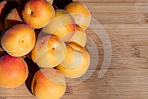 Close up of ripe Blenheim apricots freshly picked, on a wooden table, California