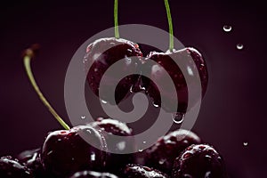 Close up of ripe juicy sweet cherries with water drops in a ceramic bowl