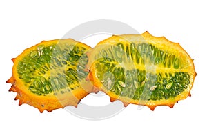 Close-up of a ripe Kiwano or Horned Melon fruit, sliced length-wise, isolated on white