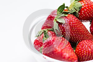 Close up of ripe red strawberries over white