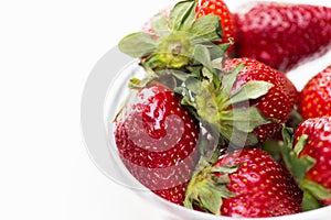 Close up of ripe red strawberries over white
