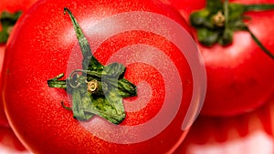 Close up of ripe red tomato, tomatoes background