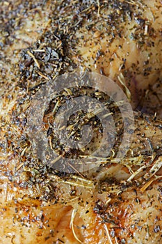 Close-up of a roast chicken seasoned with herbs. Herbs include sage, thyme, marjoram, oregano, parsley and rosemary