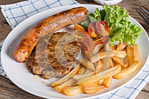 Close up, Roasted beef meat steak and sausage with french fries.