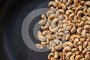 Close-up Roasted cashew nuts and  salt in a pan.Concept Health