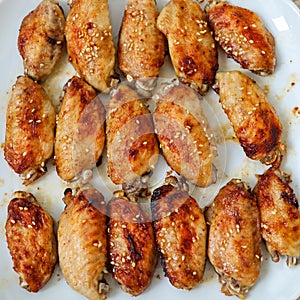 Close up roasted chicken buffalo wings close up, macro party food on white plate