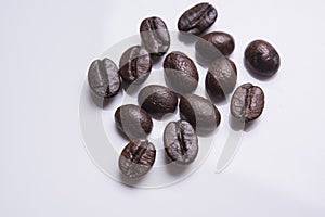 Close-up of roasted coffee beans heap isolated on white. Studio
