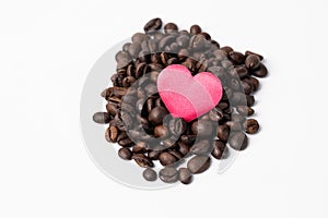 Close-up Roasted coffee beans and red heard on middle on white background