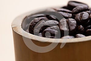 Close-up roasted coffee beans, seeds on wooden background with copy space using for drink menu ingredient, espresso, cappucino,