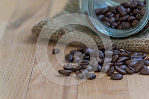 Close up of Roasted coffee beans on  wooden background with copy space