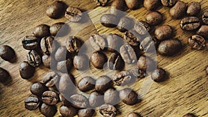 Close up of roasted coffee beans on wooden table. Top view.
