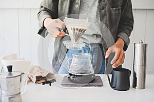 Close up. roasted coffee on coffee percolator with professional of a barista making coffee for dripping hot coffee into the cup