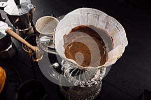 Close up. roasted coffee on coffee percolator with professional of a barista making coffee for dripping hot coffee into the cup