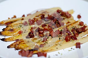 Close-up of roasted white asparagus with ham