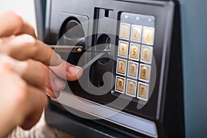 Hand Trying To Break Home Security Safe photo